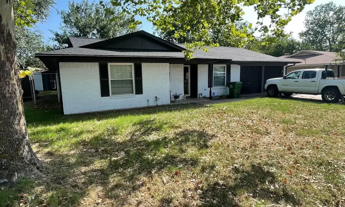 Professional roofing crew working on a residential roof in Bartlett